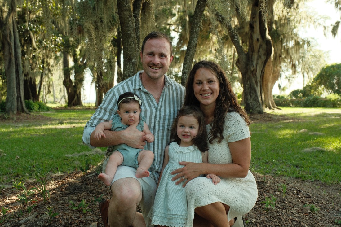 Gilbert Ackerman with his wife and two daughters under the live oaks in Nocatee, Florida