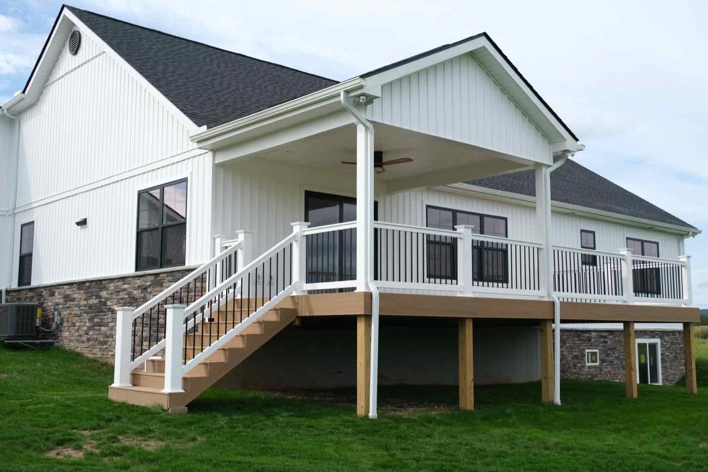 A new white home with a covered rear deck, built by Don Huey Custom Building & Remodeling