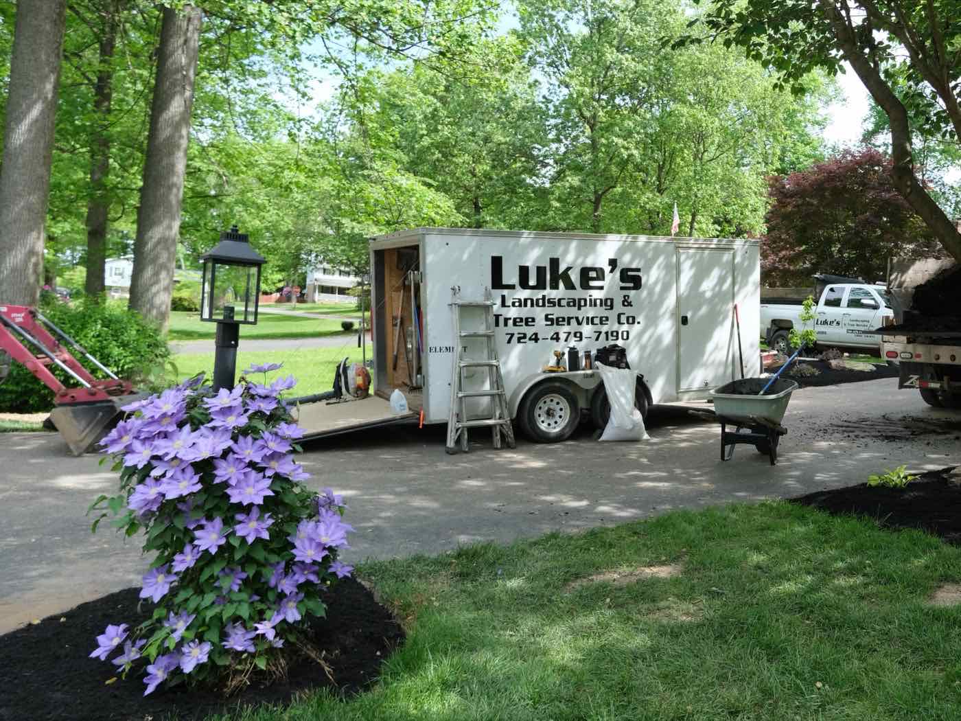 Luke’s Landscaping trailer and trucks at a freshly mulched yard